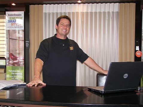 Smiling man behind a desk