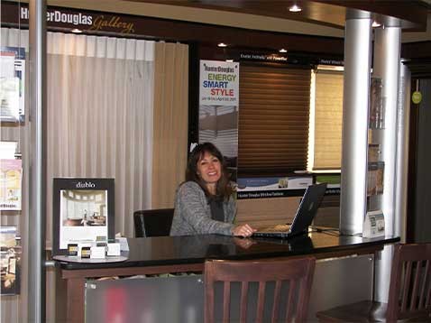 Smiling woman behind a desk